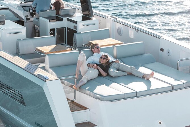Caldera Private Cruise with Fjord 52 - White Beach: pale rock and clear water